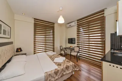 a bedroom with a bed and a table with chairs at Invictum Residence in Istanbul