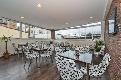 a restaurant with tables and chairs and windows at Invictum Residence in Istanbul