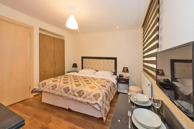 a bedroom with a bed and a flat screen tv at Invictum Residence in Istanbul