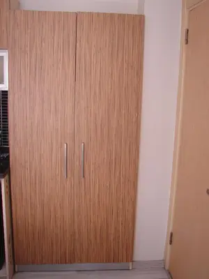 a wooden cabinet in the corner of a room at Invictum Residence in Istanbul