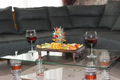 two glasses of wine and a tray of food on a coffee table at Quars Suite in Esenyurt
