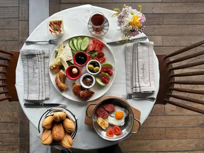 a table with a plate of breakfast food on it at Meroddi Galata Flats in Istanbul