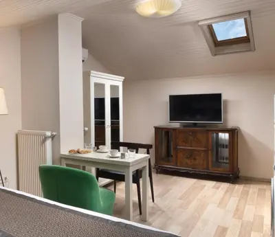 a living room with a table and a flat screen tv at Meroddi Galata Flats in Istanbul