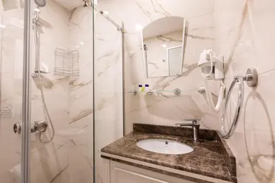 a bathroom with a sink and a shower at Villa Sweet Hotel in Istanbul