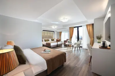 a hotel room with a bed and a living room at Pell Palace Hotel & SPA in Istanbul