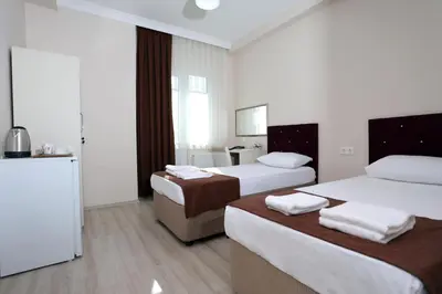 a hotel room with two beds and a bathroom at BEKSİTİ HOTEL in Yalova