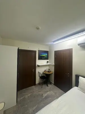a bedroom with a bed and a table and a desk at Campus Boutique Hotel in Istanbul