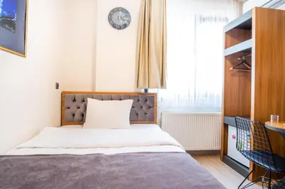 a small bedroom with a bed and a window at Campus Boutique Hotel in Istanbul