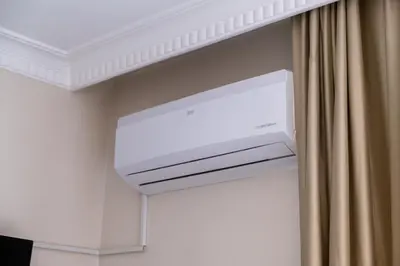 a white air conditioner in a room with a curtain at Campus Boutique Hotel in Istanbul