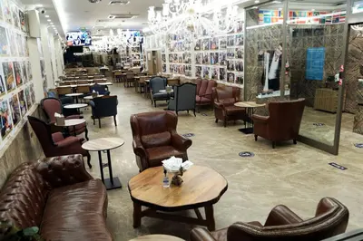 a restaurant with leather furniture and tables and chairs at Almadina Hotel Istanbul in Istanbul
