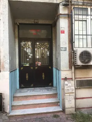 an entrance to a building with a black door at Çatı Apartment in Istanbul