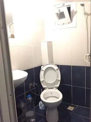 a bathroom with a toilet and a sink at Çatı Apartment in Istanbul