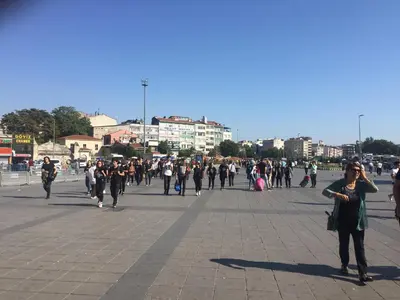 a large group of people walking down a street at Çatı Apartment in Istanbul