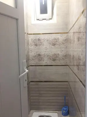 a bathroom with a toilet and a window at Eda's Apartment in Istanbul