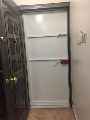 a white garage door in front of a door at Eda's Apartment in Istanbul