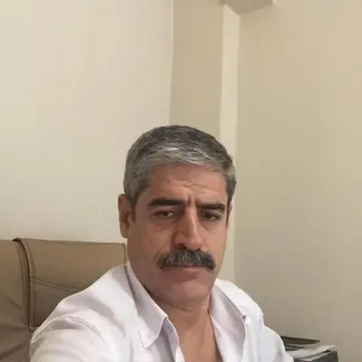 a man with a mustache sitting in a chair at Eda's Apartment in Istanbul