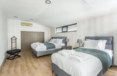 two beds in a room with white and blue at DM Suites Bosphorus in Istanbul