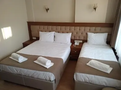 two beds in a room with white sheets and pillows at Ribad Hotel Sultanahmet in Istanbul