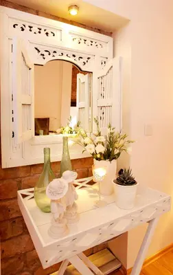 a white table with vases and a mirror at The White Swan Suites Beyoglu in Istanbul