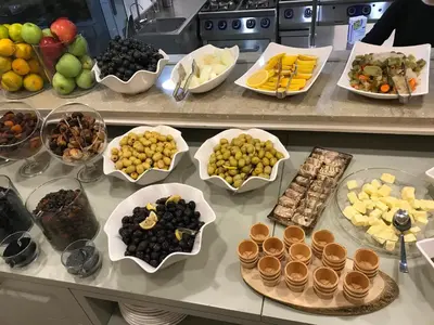 a counter with a bunch of different types of food at GALATAHAN Hotel Istanbul Karakoy in Istanbul