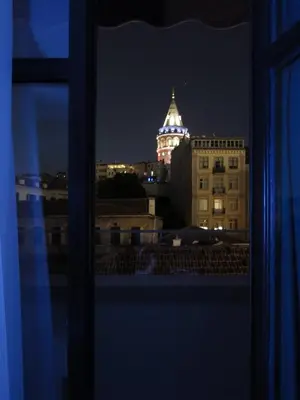 a view of a building with a clock tower at night at GALATAHAN Hotel Istanbul Karakoy in Istanbul