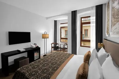 a hotel room with a bed and a television at Akka Suites Taksim-Special Class in Istanbul