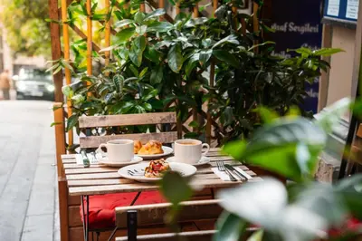 a table with two cups and a plate of food at Akka Suites Taksim-Special Class in Istanbul