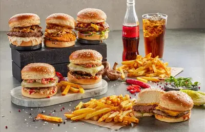 a group of sandwiches and french fries and a drink at Yeşilyurt Park Otel in Corlu