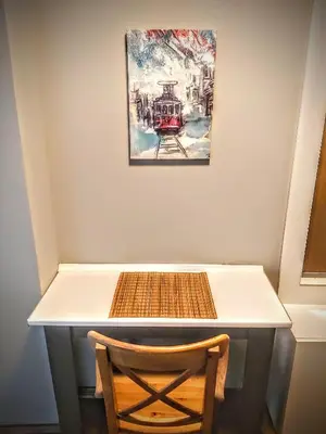 a table with a chair and a painting on the wall at Rodos HAN in Istanbul