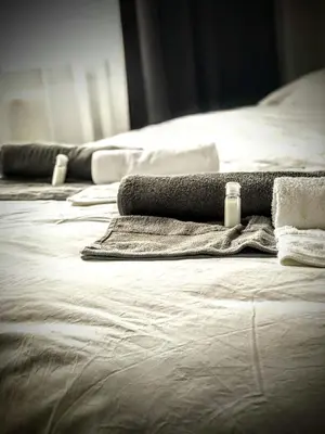 three beds with towels and a bottle of soap on them at Rodos HAN in Istanbul