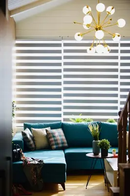 a blue couch in a living room with a large window at LUXIR HOTEL in Istanbul