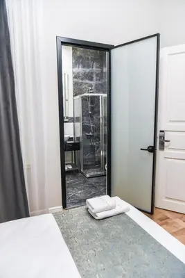 a bedroom with a door with a mirror and a rug at LUXIR HOTEL in Istanbul