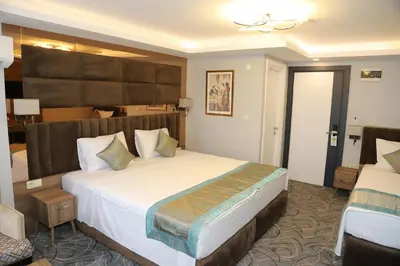 a hotel room with a large bed in a room at Grand Kavi Hotel in Istanbul