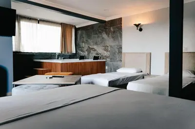 a room with three beds and a desk in it at Beach Butik Hotel Şile in Istanbul