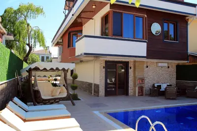 a house with a swimming pool in front of a house at Beach Butik Hotel Şile in Istanbul