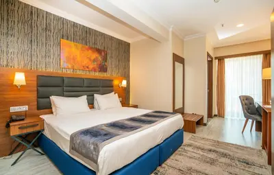 a hotel room with a bed and a desk at The Bostancı Otel in Istanbul