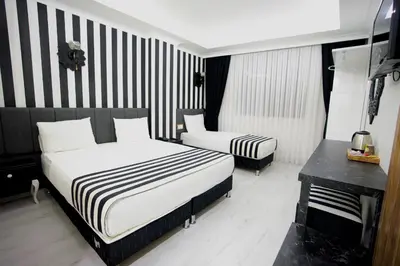 a hotel room with two beds and a piano at Cnr İnci Hotel in Istanbul