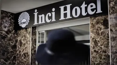 a man walks in front of an india hotel sign at Cnr İnci Hotel in Istanbul