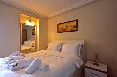 a bedroom with a large white bed with towels on it at Sunshine Taksim Suite in Istanbul