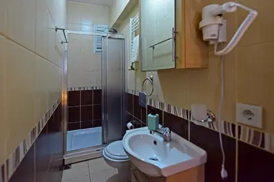 a bathroom with a sink and a toilet and a shower at Sunshine Taksim Suite in Istanbul