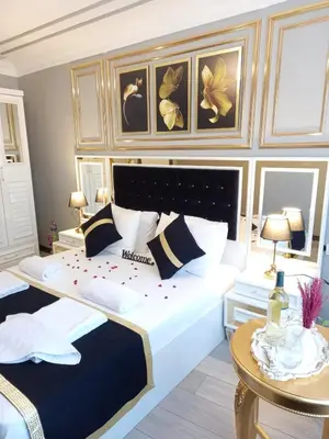 a bedroom with a large bed and a table at Emirhan Guesthouse & Suites in Istanbul