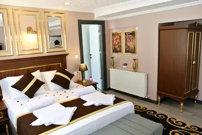 a bedroom with a large bed with white pillows at Emirhan Guesthouse & Suites in Istanbul
