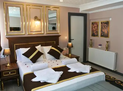 a bedroom with a large bed with pillows on it at Emirhan Guesthouse & Suites in Istanbul