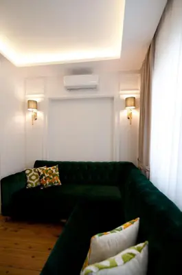a living room with a green couch with pillows at Blue Mosque Suites 2 - Old City Sultanahmet in Istanbul
