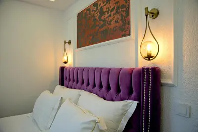 a bed with a purple headboard in a room at Blue Mosque Suites 2 - Old City Sultanahmet in Istanbul