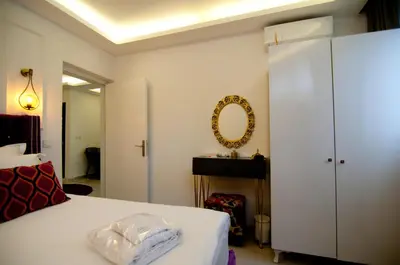 a bedroom with a white bed and a mirror at Blue Mosque Suites 2 - Old City Sultanahmet in Istanbul