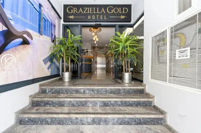 a lobby of a hotel with stairs and plants at Graziella Gold Hotel in Istanbul