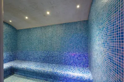 a blue tiled bathroom with a tub with blue tiles at Graziella Gold Hotel in Istanbul