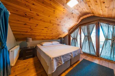 a bedroom with a bed in a wooden ceiling at antik river house in Sile