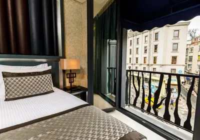 a bedroom with a balcony with a bed and a window at Euro Design Hotel in Istanbul